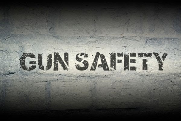  image showing text 'gun safety' on a brick wall