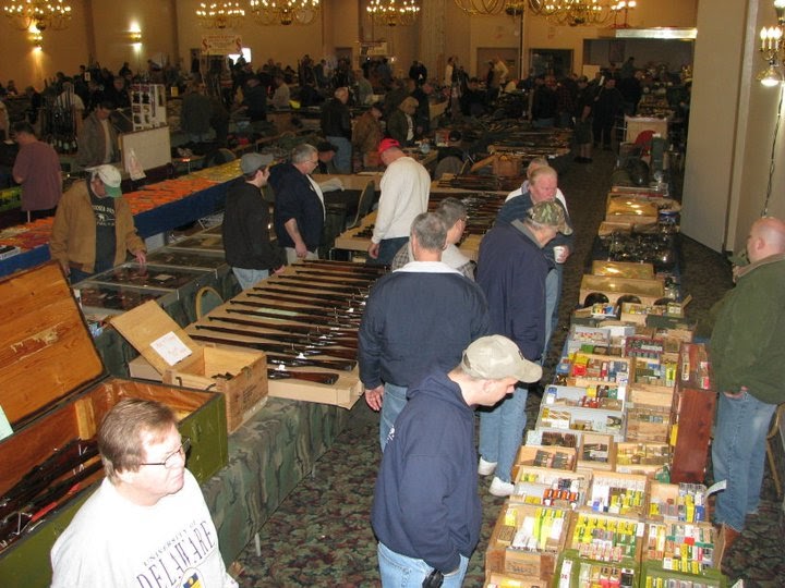 High level view showing attendees browsing products at a gun show