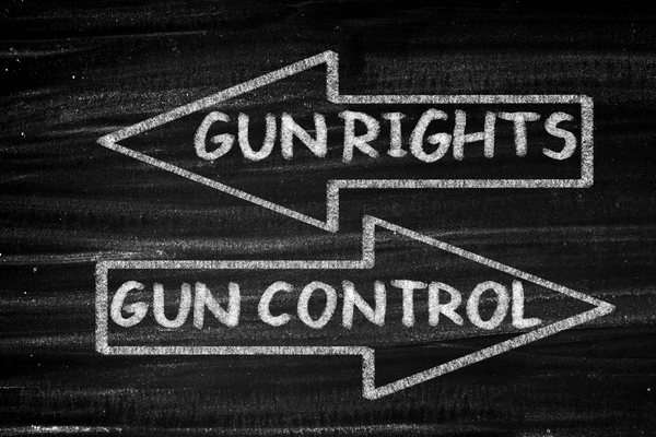 black board with the words gun rights and gun control in arrows pointing opposite directions