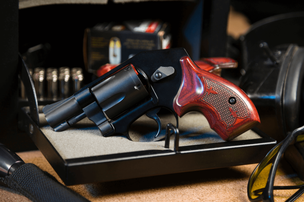 Revolver hand gun with a gun safe and shooting accessories