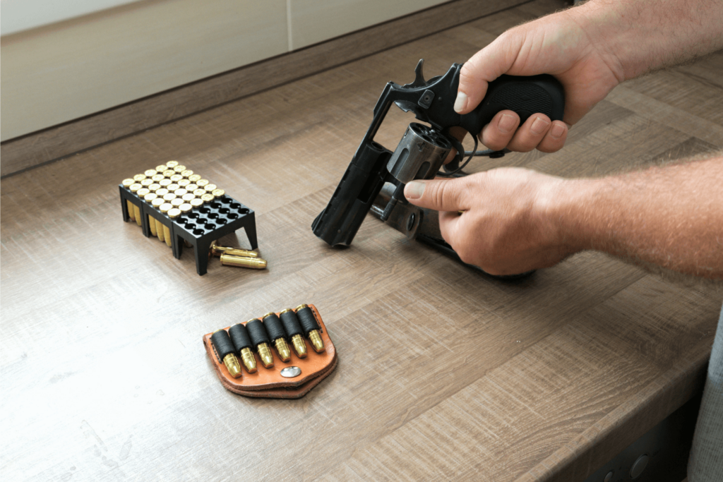 Man Reloading Ammunition into a Revolver