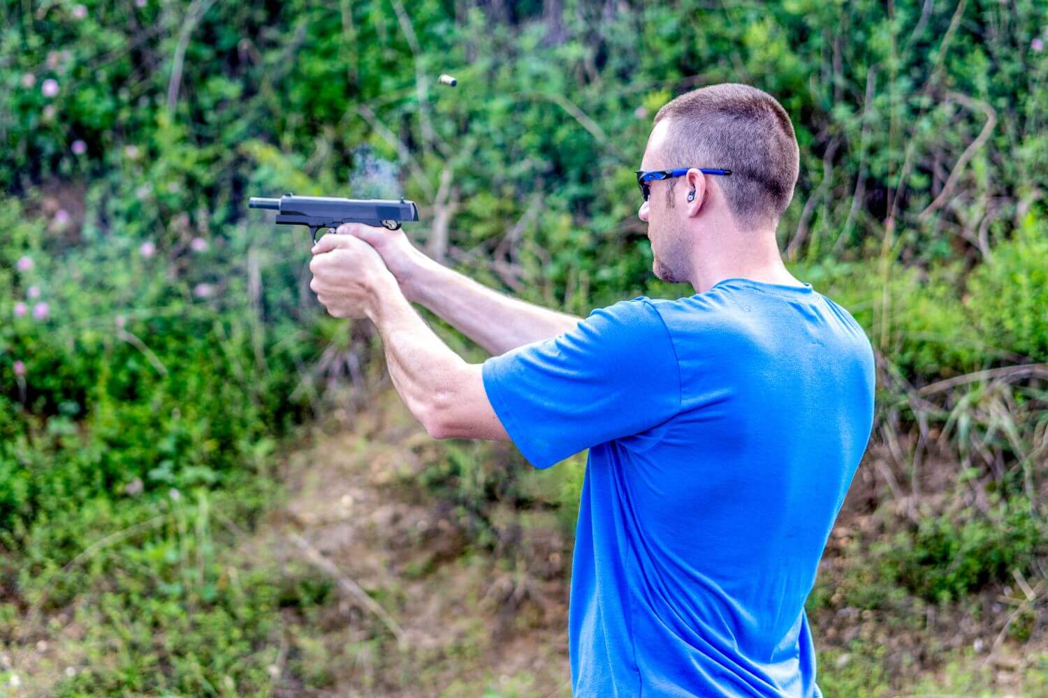 Man practicing shooting his firearm to improve accuracy