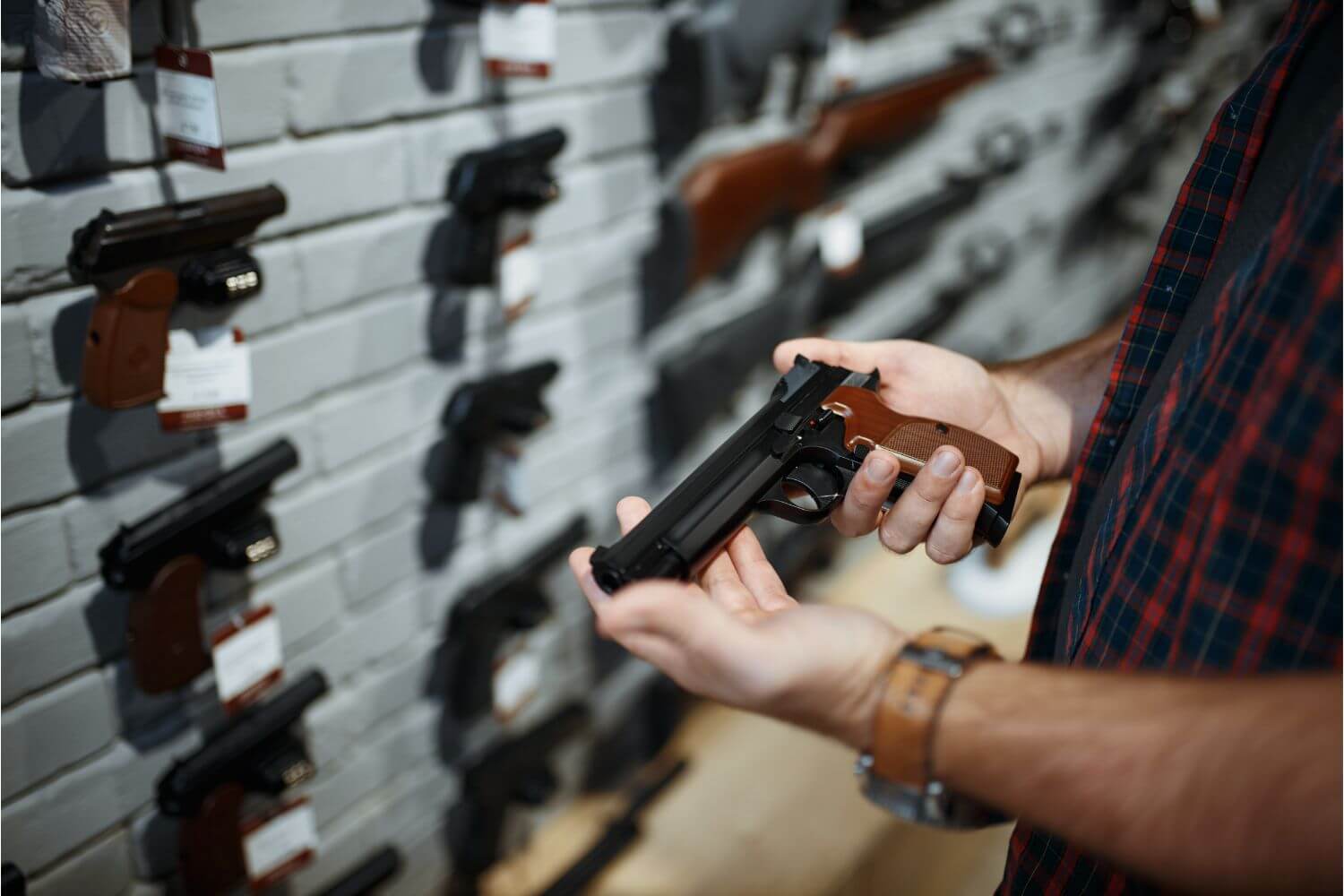 Man holding a handgun at a gun shop