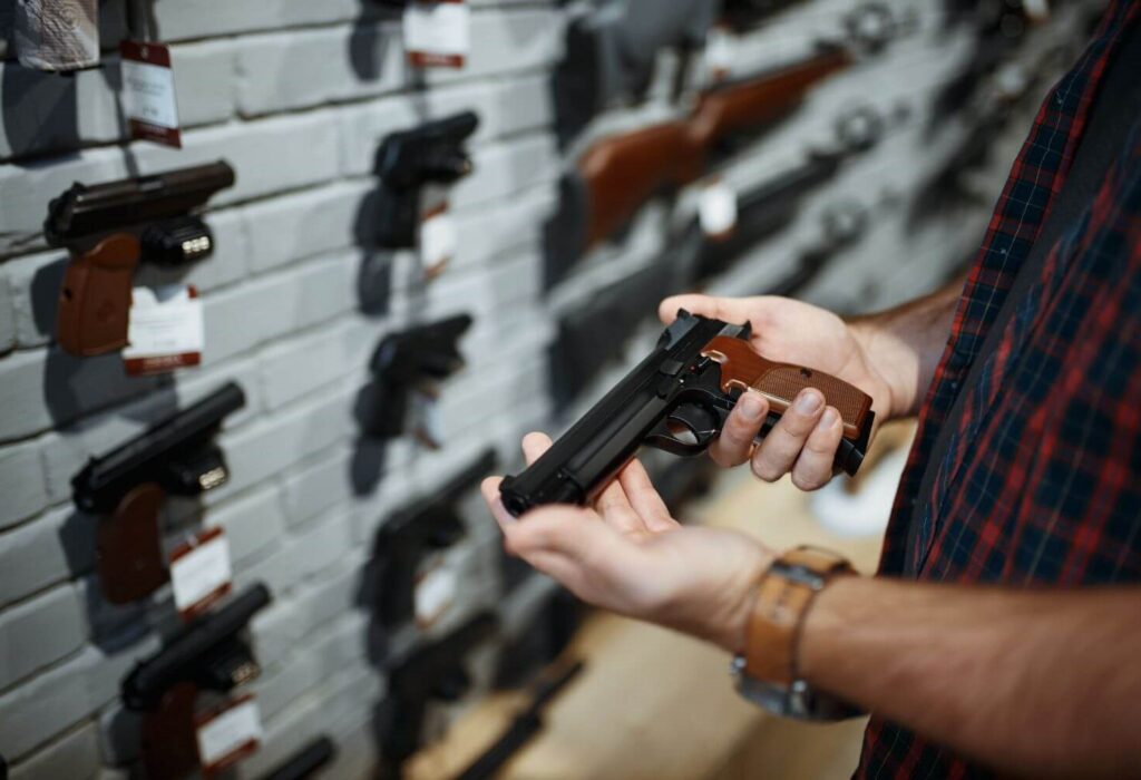Man holding a handgun in a gun shop