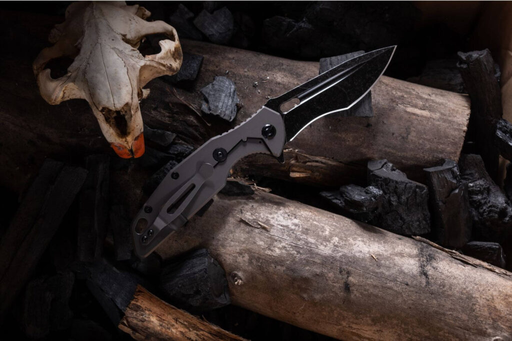 tactical knife sitting on top of wood log
