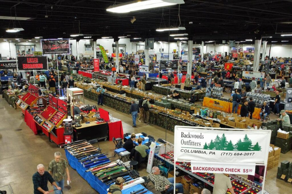 Vendor tables and customers browsing at the Oaks Gun Show in Oaks, PA