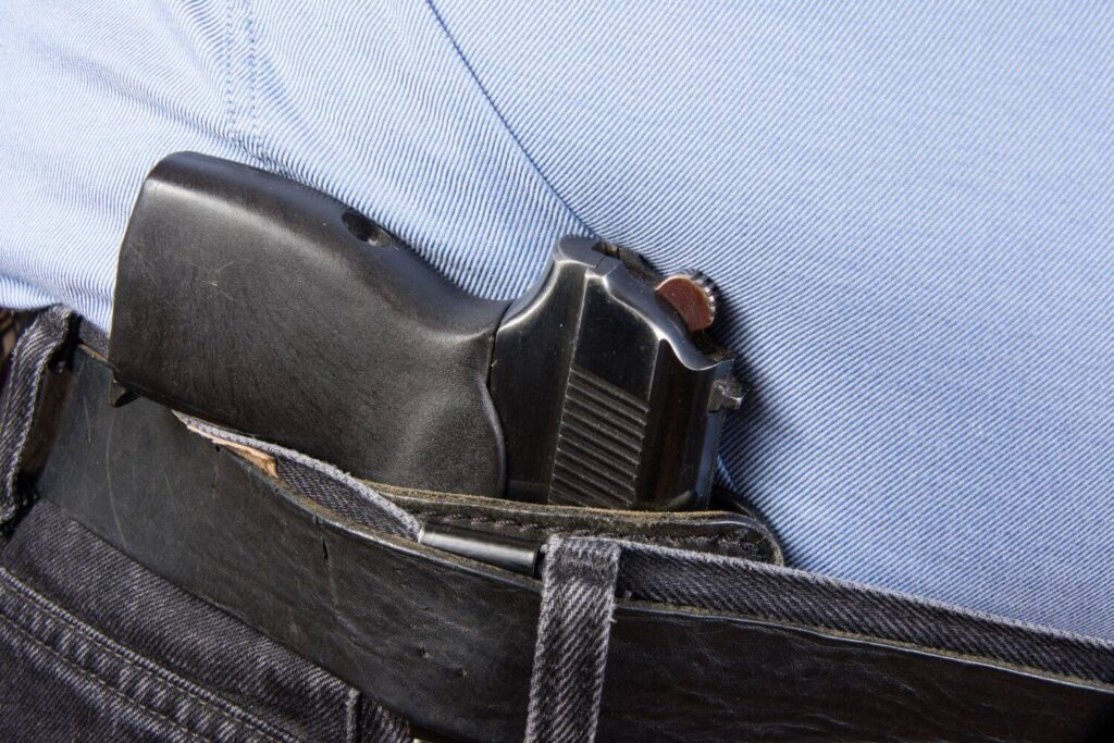 Concealed 9mm Pistol Inside the Waistband of Black Jeans