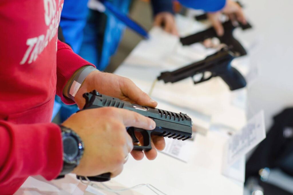 Man Holding a Pistol at a Gun Show