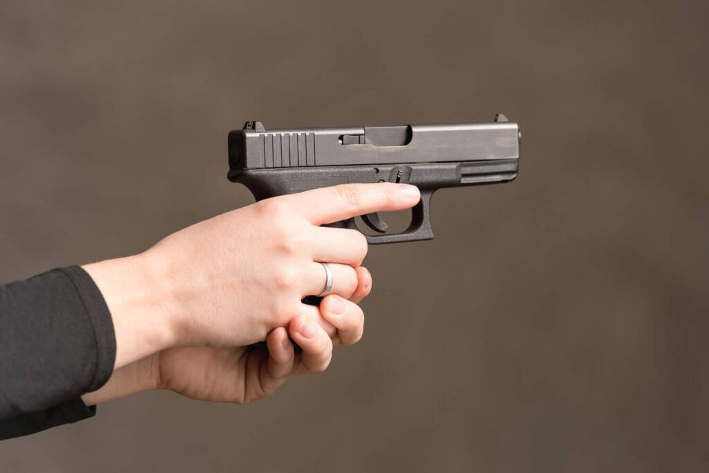 a Woman Gripping a Compact Handgun