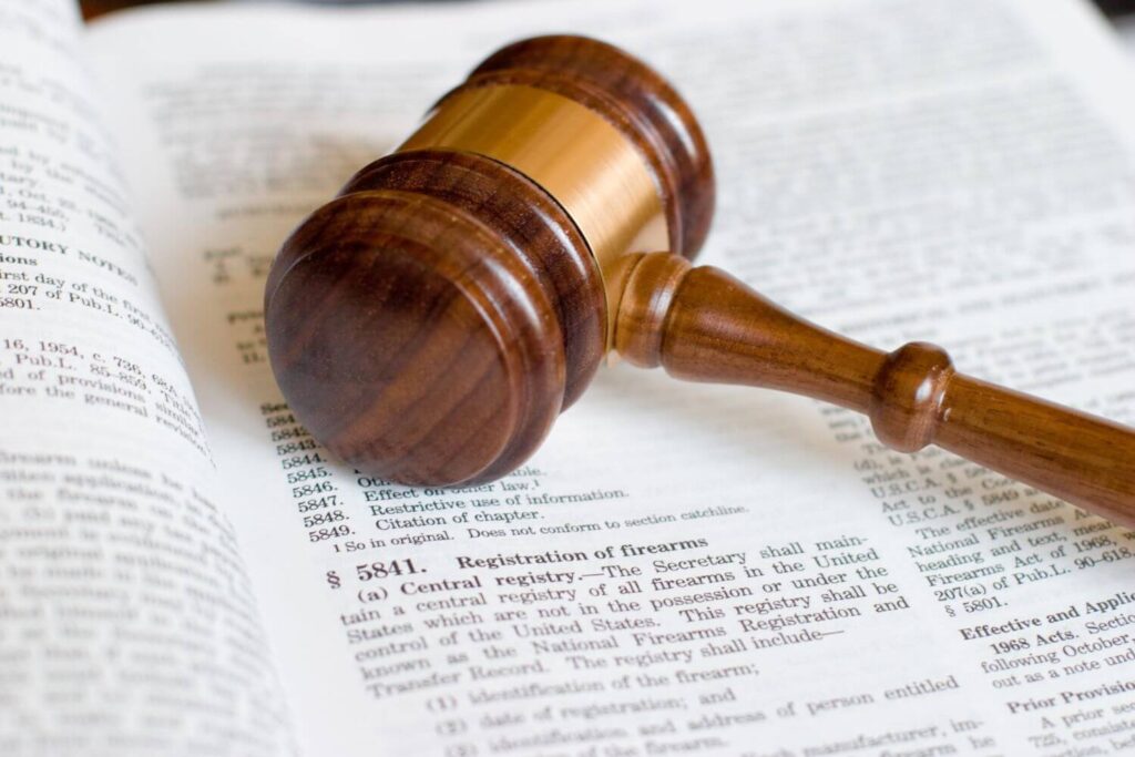 Wooden Gavel Placed on Top of a Us Law Book