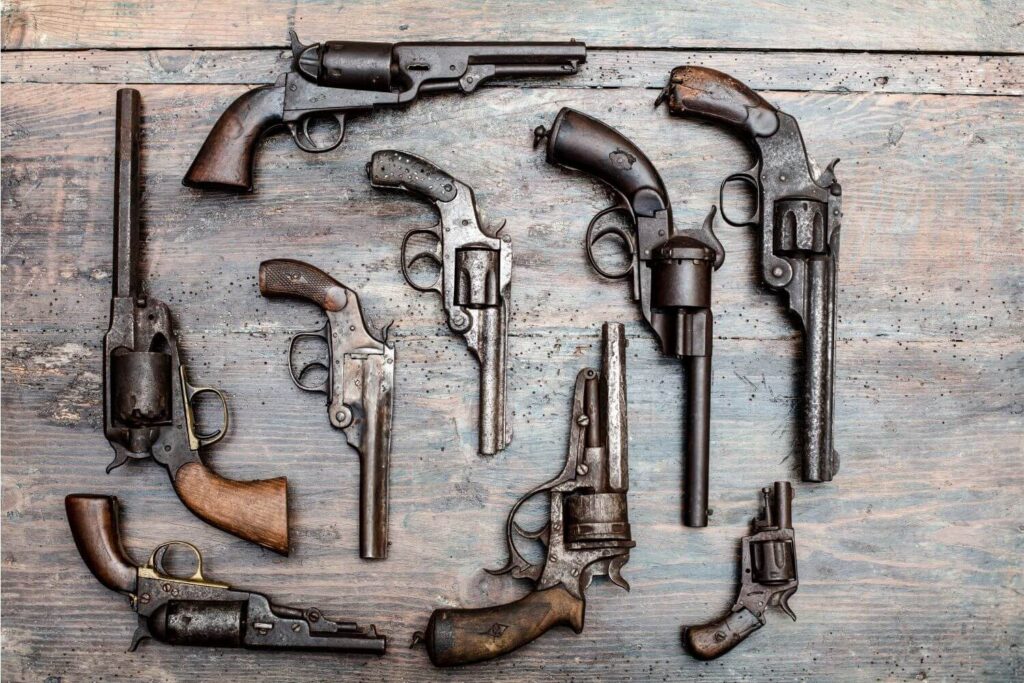 Collection of Different Types of Guns Laid out on a Table