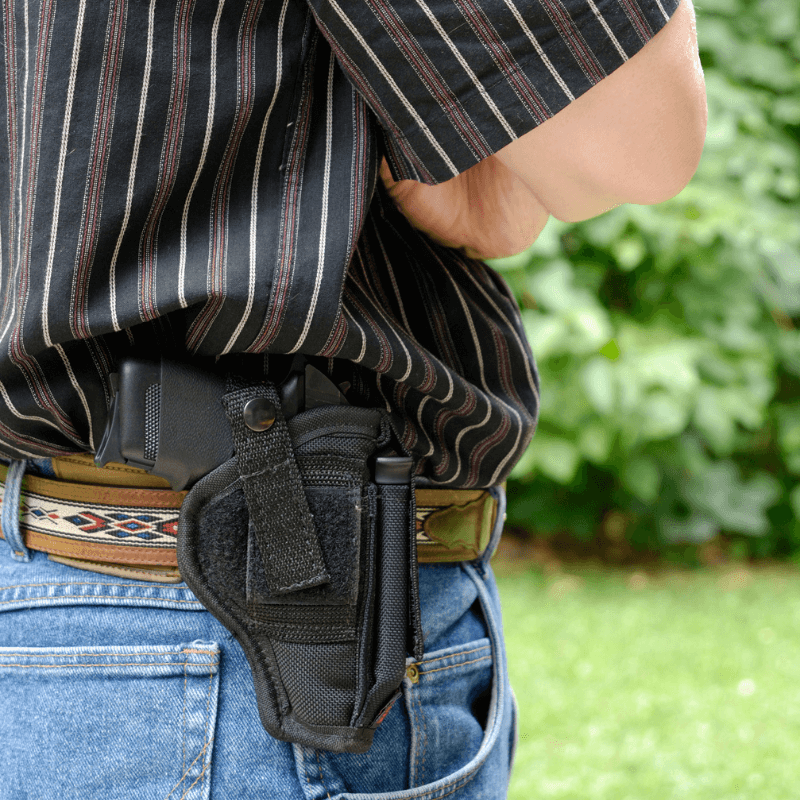 man wearing a black waistband holster for his firearm - Pennsylvania Gun Shows | Get Tickets For Eagle Shows Man Wearing a Black Waistband Holster for His Firearm