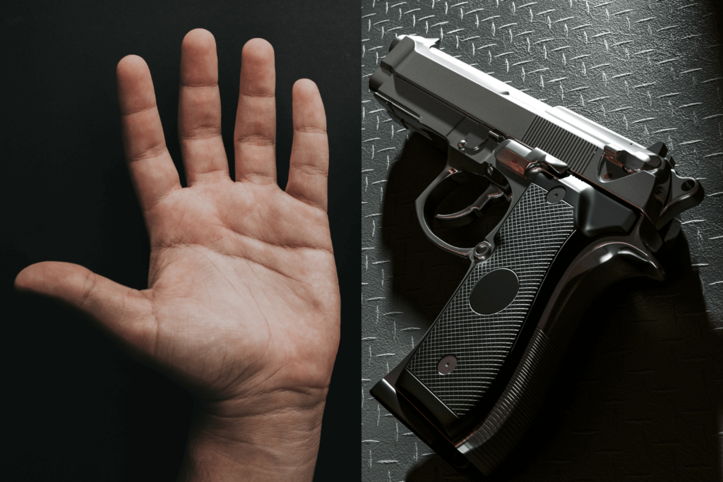 a Persons Left Hand Next to a Gun