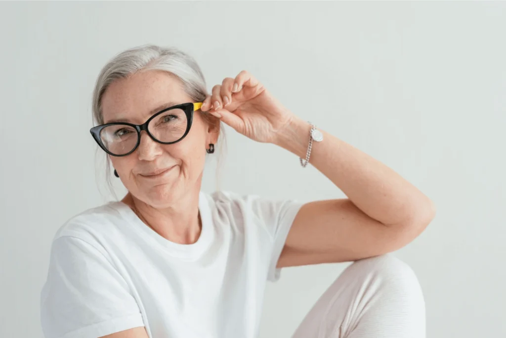 Older woman sitting down wearing a pair of eye glasses - Pennsylvania Gun Shows | Get Tickets For Eagle Shows Older Woman Sitting Down Wearing a Pair of Eye Glasses