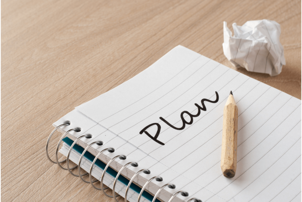 Notebook with the word plan written in it pencil lying on top of it and crumbled-up paper next to it - Pennsylvania Gun Shows | Get Tickets For Eagle Shows Notebook with the Word Plan Written in It Pencil Lying on Top of It and Crumbled up Paper Next to It