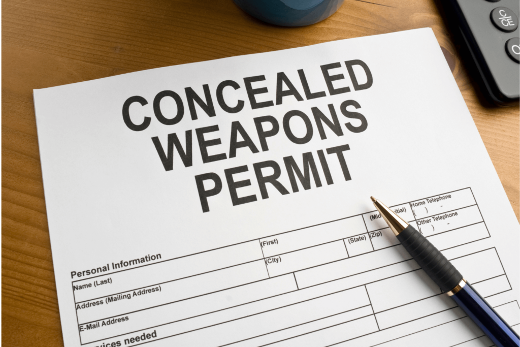 Paper That Reads concealed Weapons Permit with a Pen Lying on It