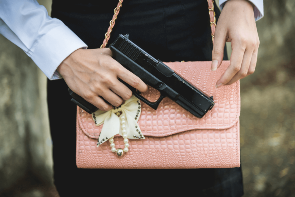 Woman Carrying a Handgun Pressed Up Against Her Pink  Purse