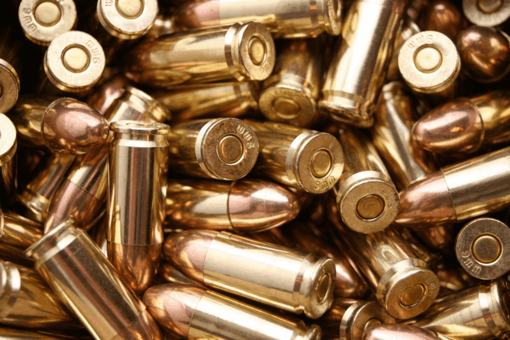 a Close up View of Brass Colored Bullet Casings That Are Stacked Up and Overlapping