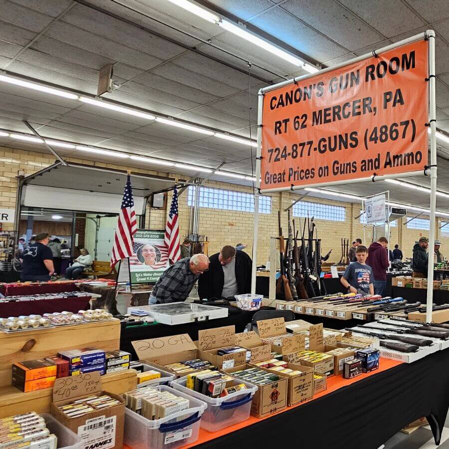 Men looking at a vendor table with guns at a PA gun show hosted by Eagle Shows - Eagle Shows | Pennsylvania Gun Shows | Get Tickets Now Men Looking at a Vendor Table with Guns at a Pa Gun Show Hosted by Eagle Shows